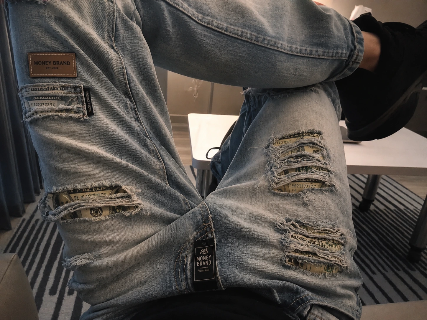 Original Money Brand distressed denim and currency-inspired panel concept